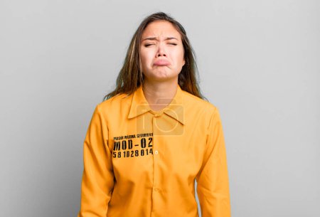 Photo for Hispanic pretty woman feeling sad and whiney with an unhappy look and crying. guilt concept - Royalty Free Image