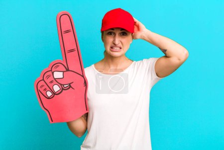 Photo for Young pretty woman feeling stressed, anxious or scared, with hands on head. number one fan concept - Royalty Free Image