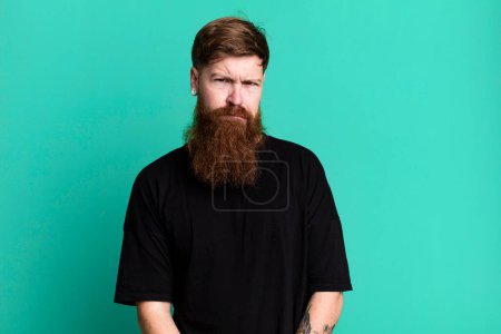 Photo for Long beard and red hair man feeling puzzled and confused - Royalty Free Image