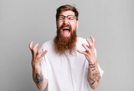 Photo for Long beard and red hair man looking desperate, frustrated and stressed - Royalty Free Image