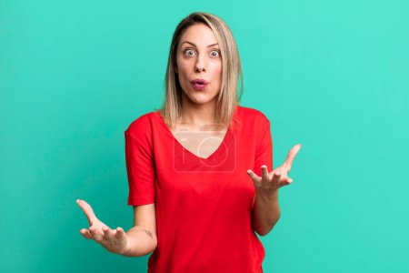 Photo for Blonde adult woman open-mouthed and amazed, shocked and astonished with an unbelievable surprise - Royalty Free Image