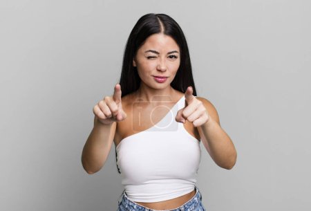 Photo for Pretty latin woman pointing forward at camera with both fingers and angry expression, telling you to do your duty - Royalty Free Image