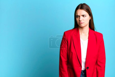 Foto de Young pretty woman feeling sad, upset or angry and looking to the side. businesswoman concept - Imagen libre de derechos