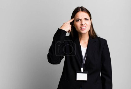 Photo for Young pretty woman feeling confused and puzzled, showing you are insane. businesswoman concept - Royalty Free Image