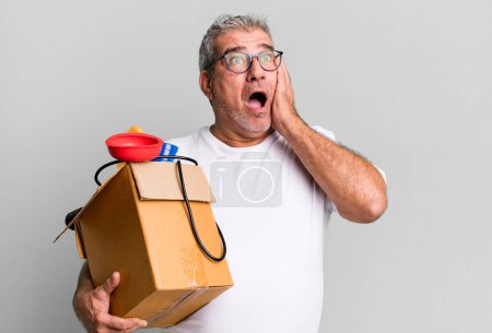 Photo for Middle age senior man feeling happy, excited and surprised. housekeeper repairman with a toolbox concept - Royalty Free Image