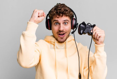 Photo for Young adult caucasian man with headset and a controller. gamer concept - Royalty Free Image