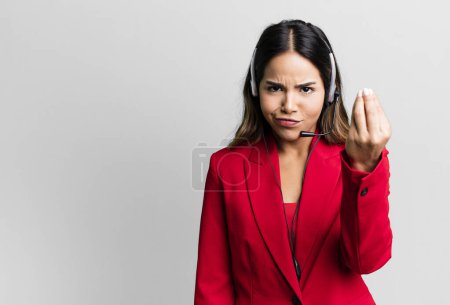 Foto de Hispanic pretty woman making capice or money gesture, telling you to pay. telemarketing concept - Imagen libre de derechos
