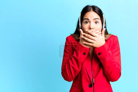 Photo for Hispanic pretty woman covering mouth with hands with a shocked. telemarketing concept - Royalty Free Image