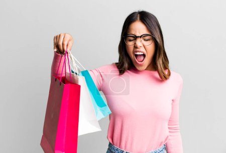 Photo for Hispanic pretty woman shouting aggressively, looking very angry. shopping concept - Royalty Free Image