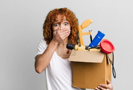 Photo for Red hair pretty woman covering mouth with hands with a shocked. housekeeper and toolbox concept - Royalty Free Image