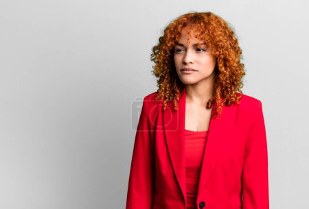 Photo for Red hair pretty woman feeling sad, upset or angry and looking to the side. businesswoman concept - Royalty Free Image
