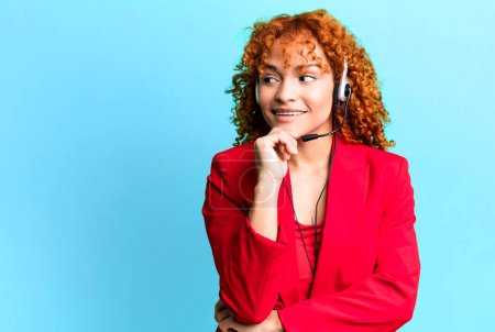 Photo for Red hair pretty woman smiling with a happy, confident expression with hand on chin. telemarketing concept - Royalty Free Image