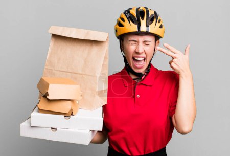 Photo for Looking unhappy and stressed, suicide gesture making gun sign. fast food delivery or take away - Royalty Free Image