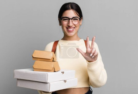 Photo for Smiling and looking friendly, showing number three. fast food delivery or take away - Royalty Free Image