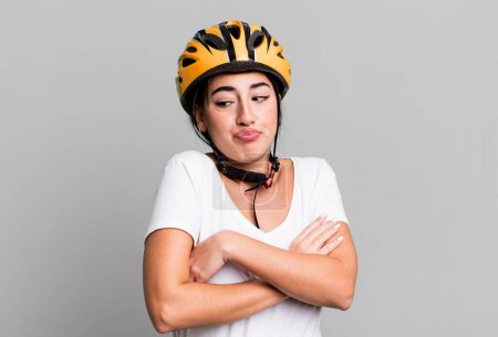 Photo for Shrugging, feeling confused and uncertain. bike helmet concept - Royalty Free Image