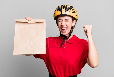 Photo for Pretty blonde deliverywoman with a paper bag - Royalty Free Image