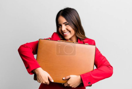 Photo for Hispanic pretty young adult woman with a suit case with banknotes - Royalty Free Image