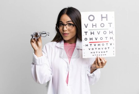 Photo for Hispanic pretty young adult woman. optical vision test concept - Royalty Free Image