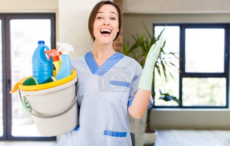 Photo for Young pretty woman feeling happy, surprised realizing a solution or idea. housekeeper concept - Royalty Free Image