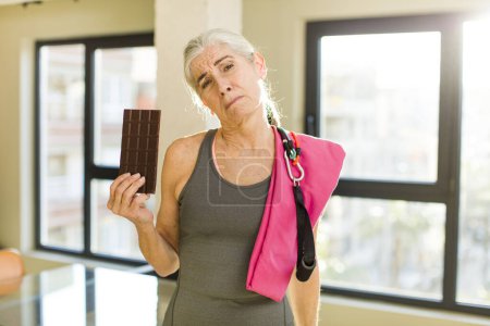 Photo for Senior pretty woman feeling sad and whiney with an unhappy look and crying. fitness concept - Royalty Free Image