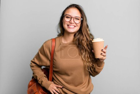 Photo for Hispanic pretty woman smiling happily and daydreaming or doubting. take away coffee concept - Royalty Free Image