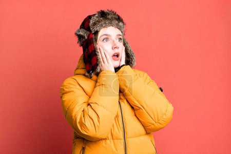 Photo for Young pretty woman feeling happy, excited and surprised. cold and coat concept - Royalty Free Image