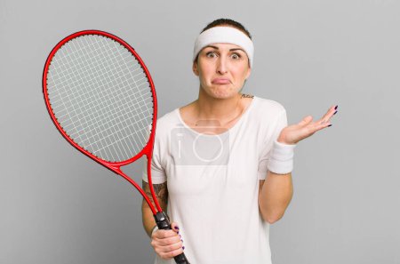 Photo for Young pretty woman feeling puzzled and confused and doubting. tennis concept - Royalty Free Image