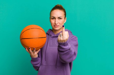 Photo for Young pretty woman feeling angry, annoyed, rebellious and aggressive. basketball concept - Royalty Free Image