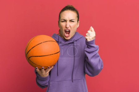 Photo for Young pretty woman shouting aggressively with an angry expression. basketball concept - Royalty Free Image