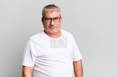 Photo for Middle age senior man feeling sad, upset or angry and looking to the side with a negative attitude, frowning in disagreement - Royalty Free Image