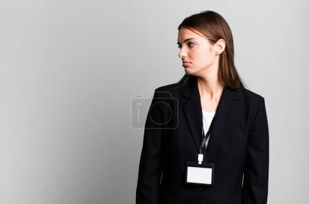 Photo for Young pretty woman on profile view thinking, imagining or daydreaming. businesswoman concept - Royalty Free Image