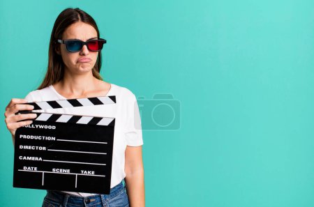 Photo for Young pretty woman feeling sad, upset or angry and looking to the side. cinema film or movie concept - Royalty Free Image