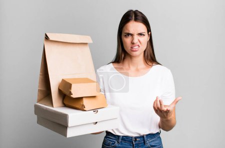 Photo for Young pretty woman looking angry, annoyed and frustrated. delivery and take away concept - Royalty Free Image