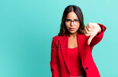 Photo for Hispanic pretty woman feeling cross,showing thumbs down. businesswoman concept - Royalty Free Image