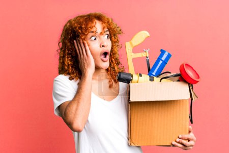 Photo for Red hair pretty woman feeling happy, excited and surprised. housekeeper and toolbox concept - Royalty Free Image