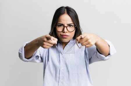 Photo for Hispanic pretty woman pointing forward at camera with both fingers and angry expression, telling you to do your duty - Royalty Free Image