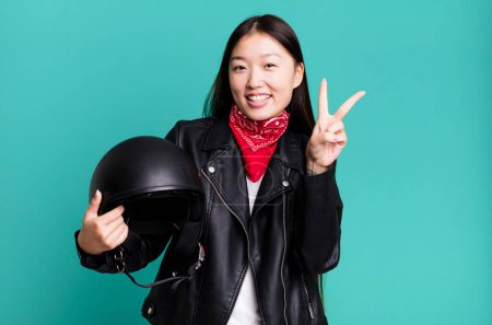 Photo for Young adult pretty asian woman. motorbike rider with leather jacket and helmet concept - Royalty Free Image