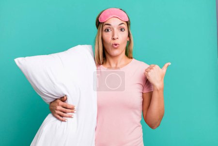 Photo for Pretty blonde woman looking astonished in disbelief. pajamas or nightwear concept - Royalty Free Image