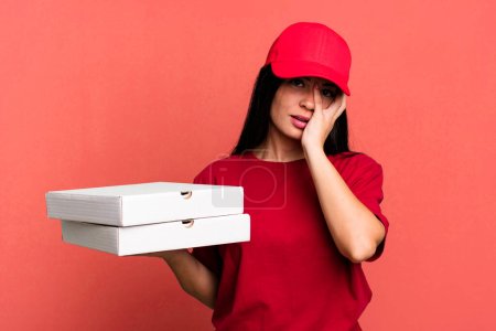 Photo for Hispanic pretty woman feeling bored, frustrated and sleepy after a tiresome. delivery pizza concept - Royalty Free Image