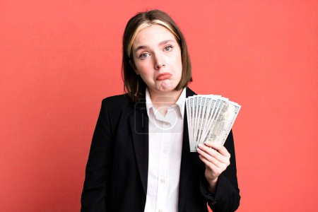 Photo for Young pretty woman feeling sad and whiney with an unhappy look and crying. dollar banknotes - Royalty Free Image