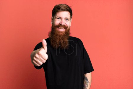 Photo for Long beard and red hair man feeling proud,smiling positively with thumbs up - Royalty Free Image