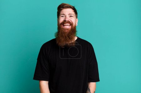 Photo for Long beard and red hair man looking happy and pleasantly surprised - Royalty Free Image