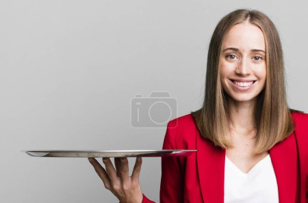 Photo for Smiling and looking happy, gesturing victory or peace. businesswoman presenting with a tray - Royalty Free Image