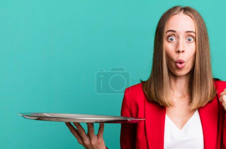 Photo for Looking astonished in disbelief. businesswoman presenting with a tray - Royalty Free Image