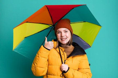 Téléchargez les photos : Young pretty woman wearing an anorak and a umbrella - en image libre de droit