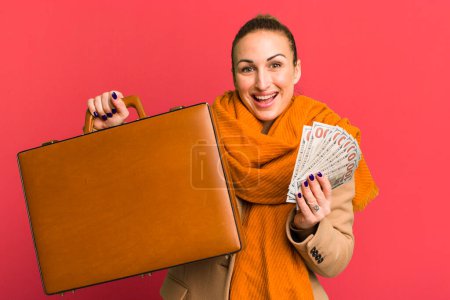 Téléchargez les photos : Young pretty woman with a leather case and dollar banknotes - en image libre de droit