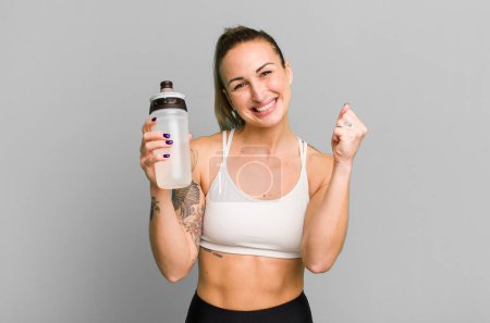 Foto de Young pretty woman with water bottle. fitness concept - Imagen libre de derechos