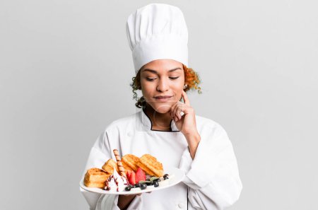 Téléchargez les photos : Red hair pretty chef woman cooking waffles - en image libre de droit