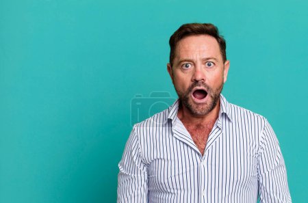 Photo for Looking very shocked or surprised, staring with open mouth saying wow - Royalty Free Image