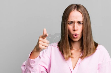 Photo for Pointing at camera with an angry aggressive expression looking like a furious, crazy boss - Royalty Free Image